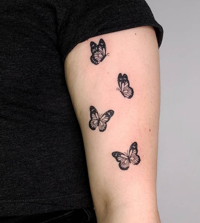 Four Black Monarch Butterflies Tattoo on Upper Arm
