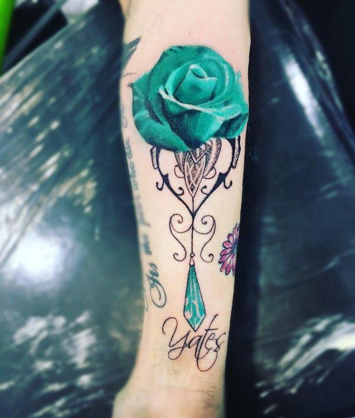 Elegant Green Rose Tattoo on Forearm
